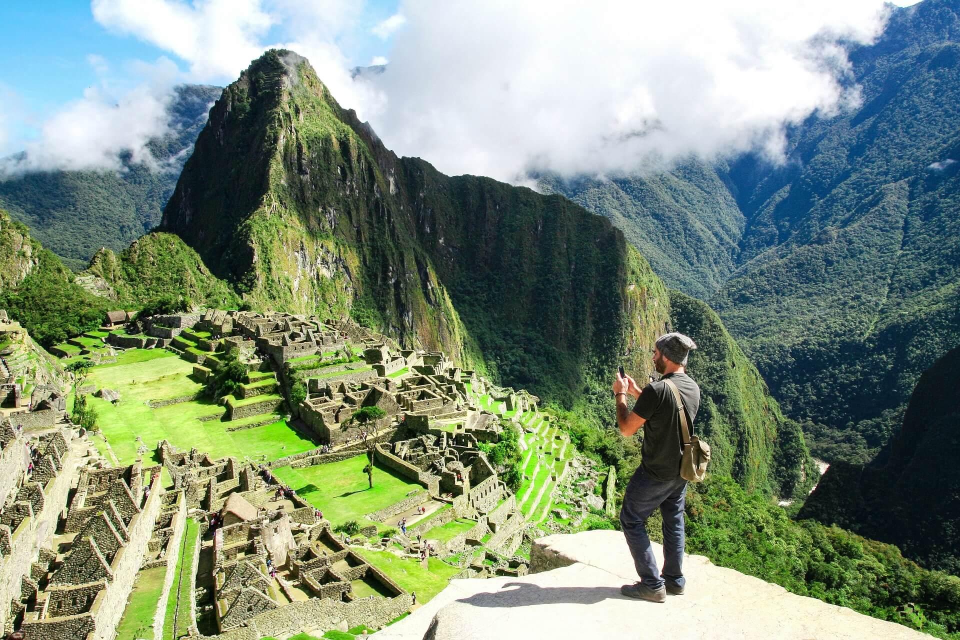 Tourist taking a photo at Machu Picchu