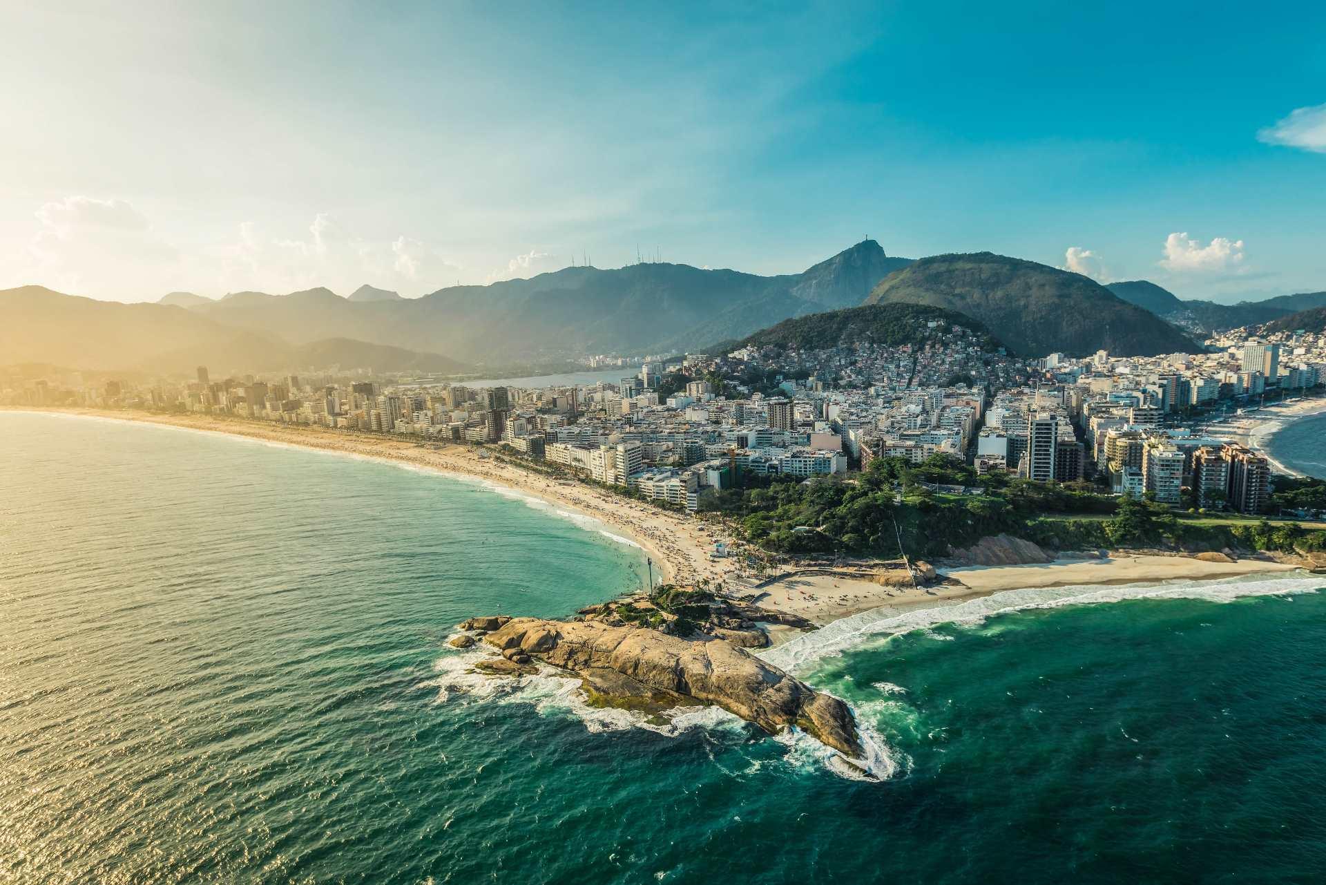 Breathtaking view of the Arpoador peninsula, framed by the beaches of Ipanema and Copacabana with their golden sands and stunning mountain backdrop.