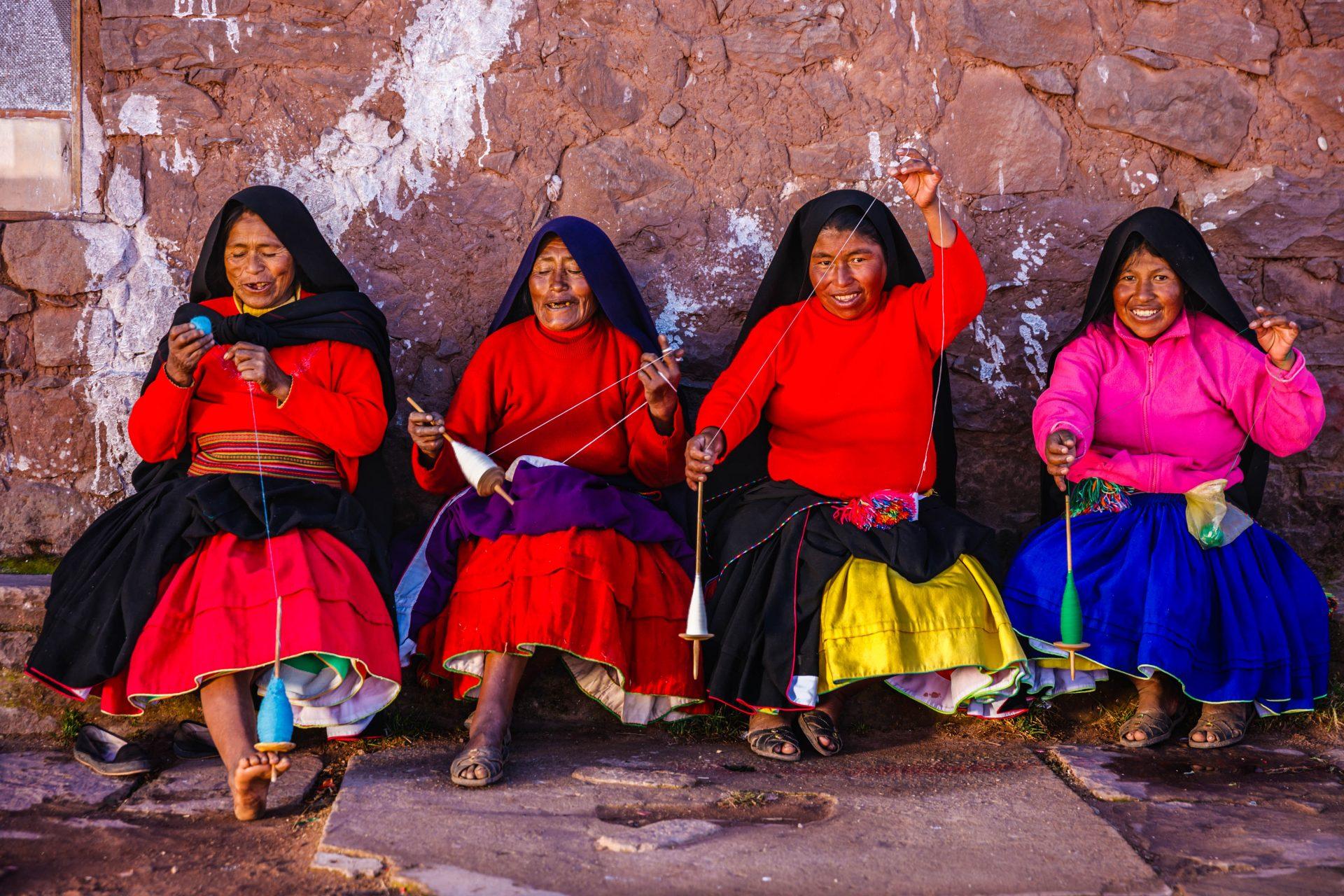 Four spinning women on the island of Taquile, Lake Titicaca, Peru, Bolivia.