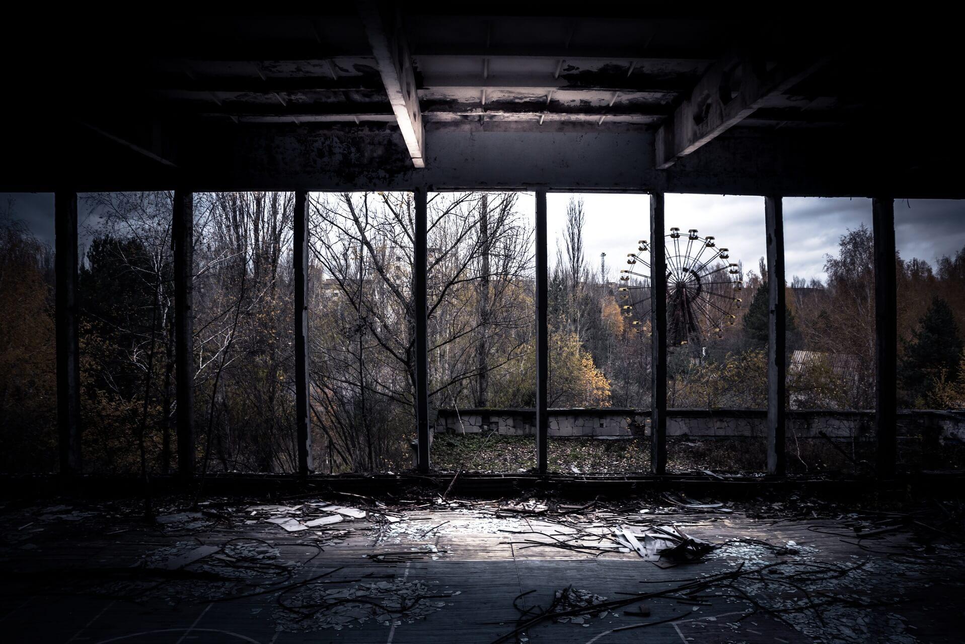 Abandoned room with a view of the Ferris wheel in the amusement park of Prypyat near Chernobyl in Ukraine is a hotspot for dark tourism.