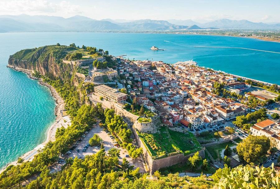 Beautiful Nafplion city in Greece, view from above with green peninsula surrounded by Mediterranean sea