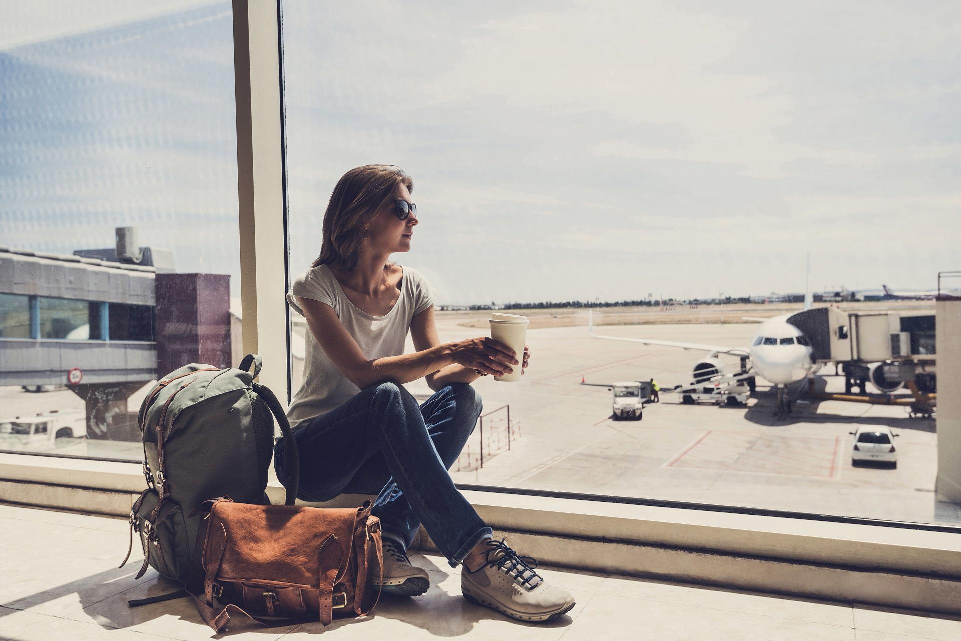 A woman waits for her flight