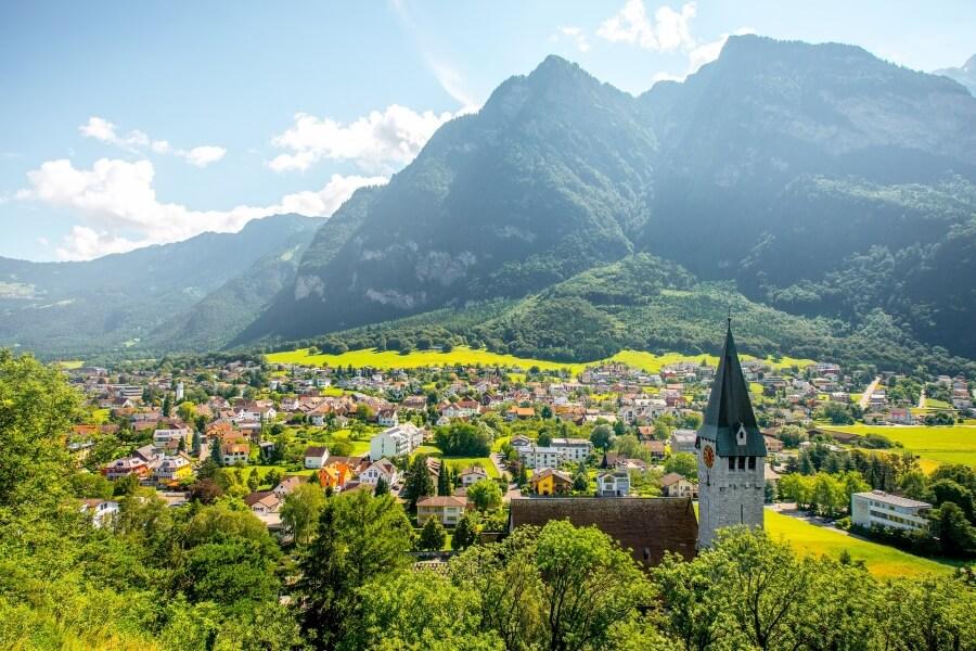 Liechtenstein is nestled in a valley and is surrounded by mountains.