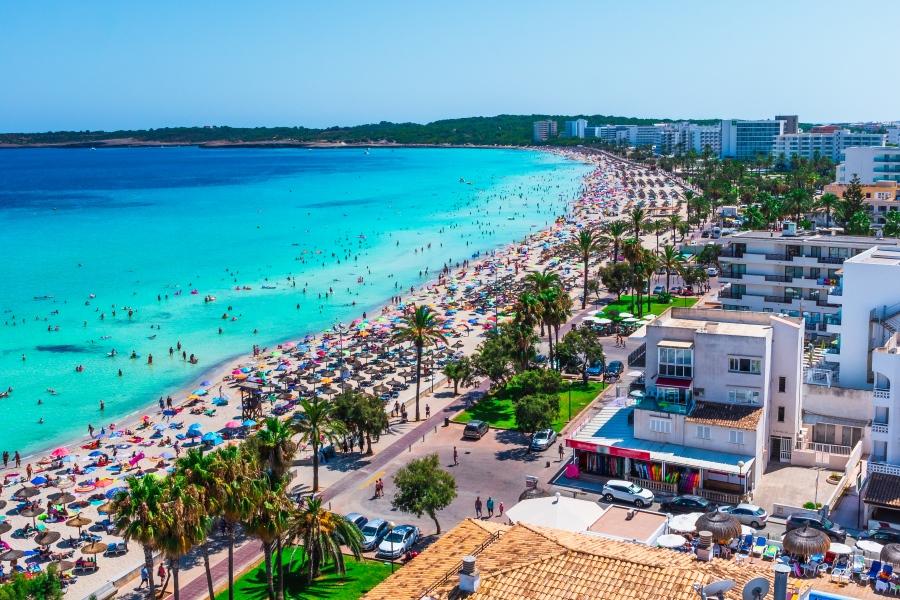 Beach in Cala Millor, Mallorca with hotels and many vacationers