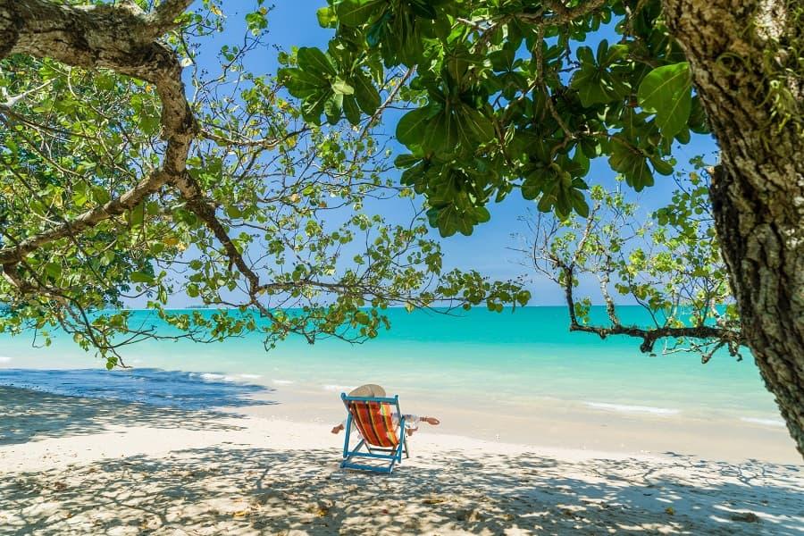 A woman relaxes on a beach in Khao Lak