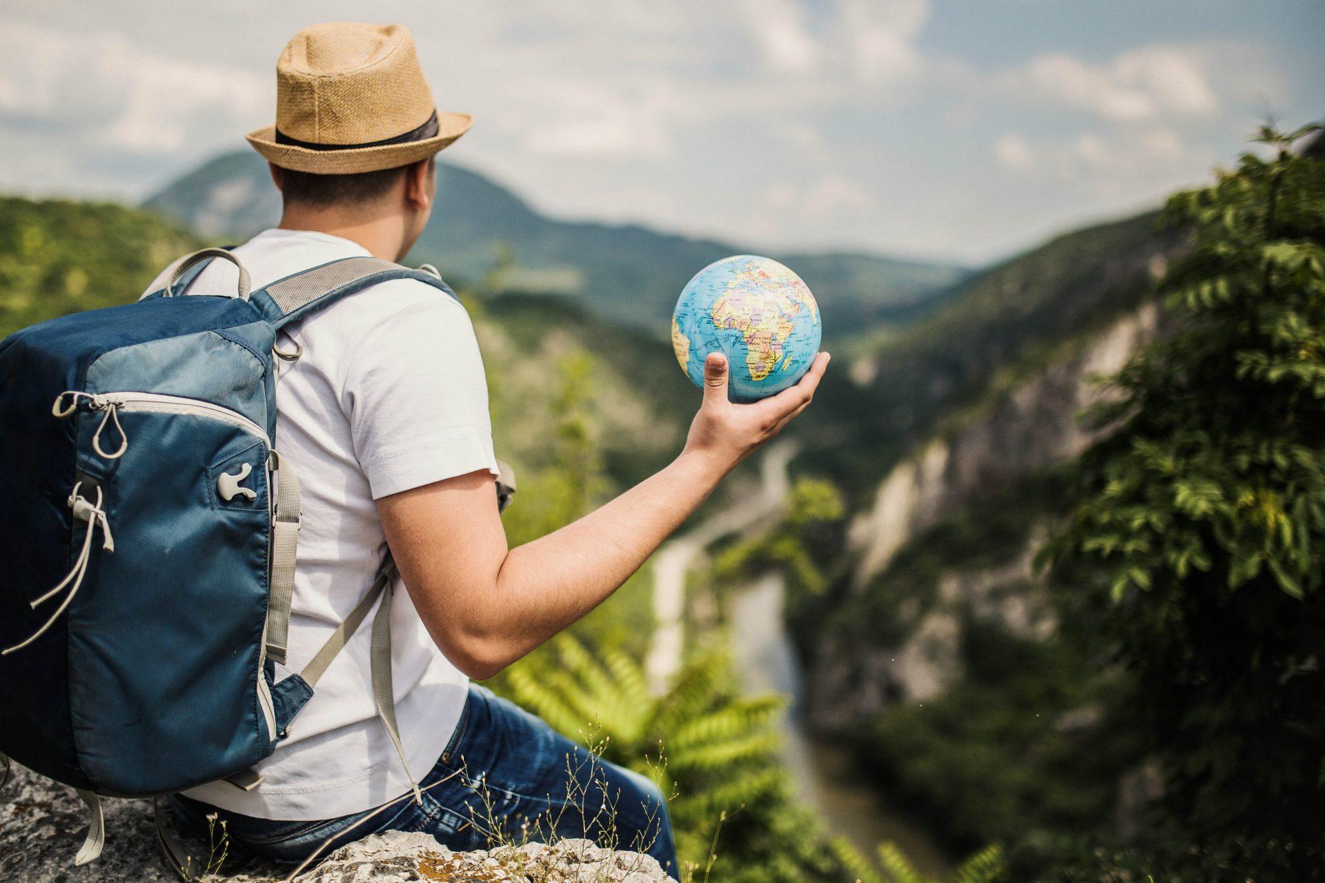 A man holding a small globe