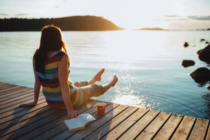 Woman by the lake in Lapland in summer