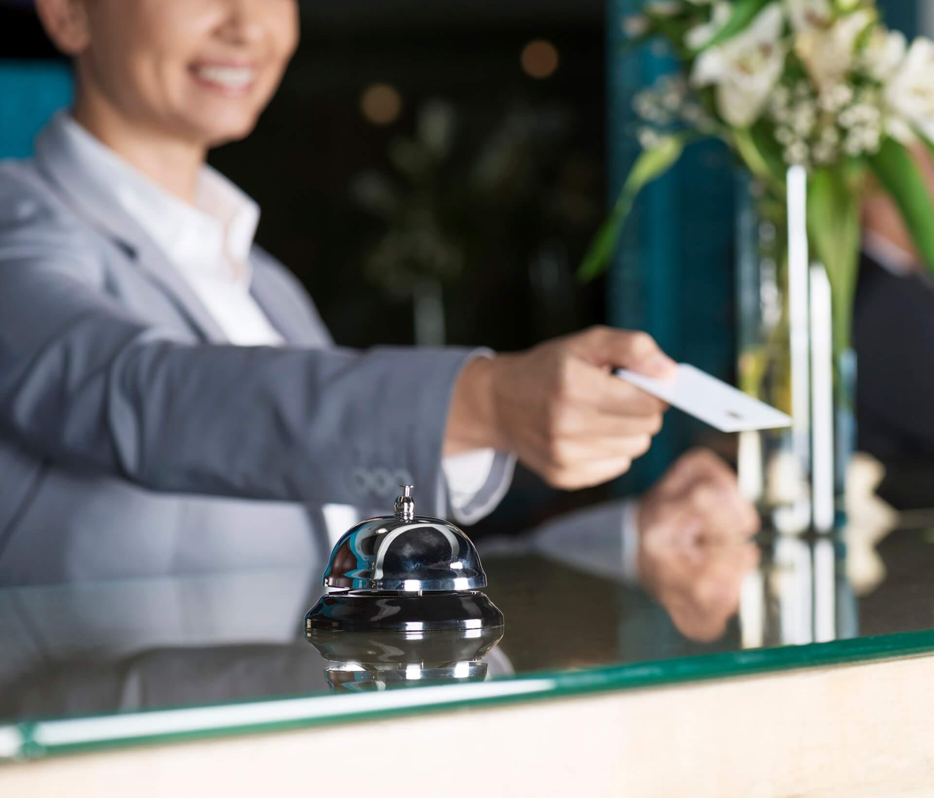 Woman hands card at hotel reception