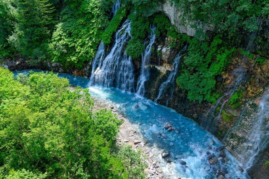 Turquoise Water at Shirahige Waterfalls in Biei, Hokkaido, Japan.