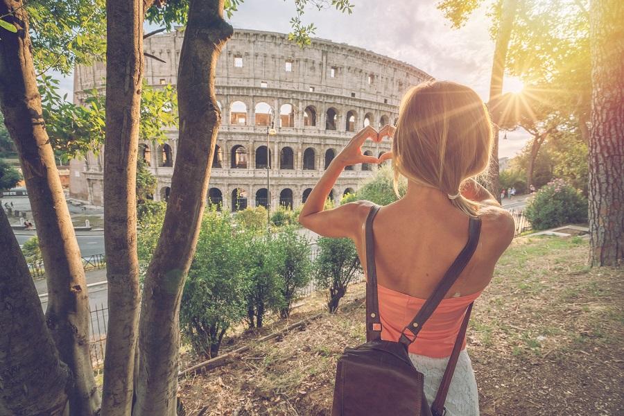 A tourist in front of the Colosseum in Rome