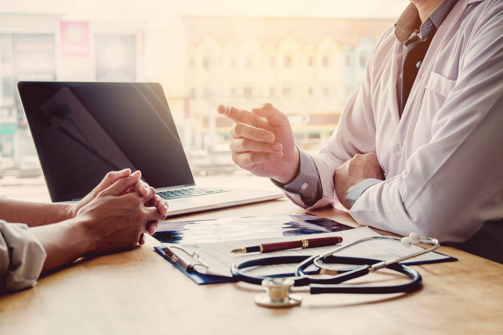 A doctor advising his patient about travel vaccinations