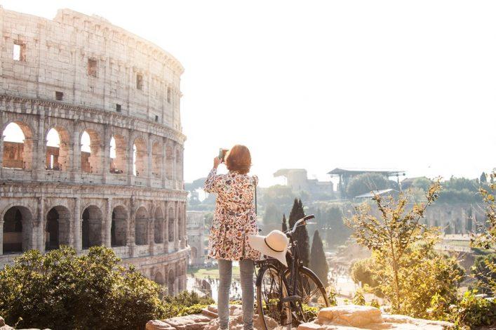 A woman in front of the Colosseum in Rome