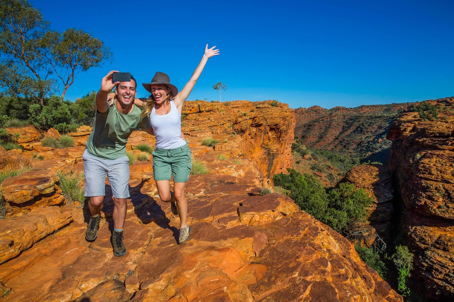 Couple taking a selfie at the Rim Walk in Kings Canyon, Northern Territory, Australia.