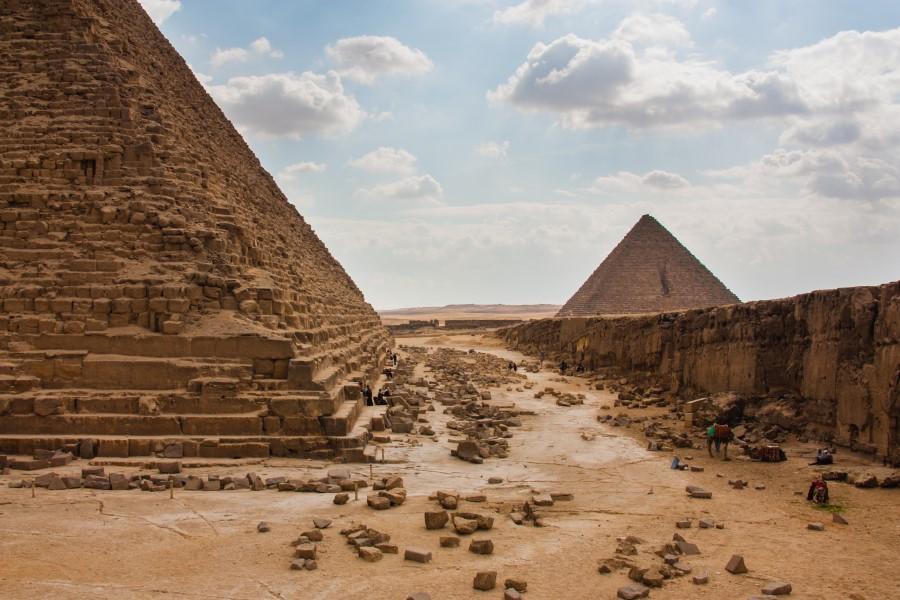 The foot of a pyramid, with another pyramid in the background.