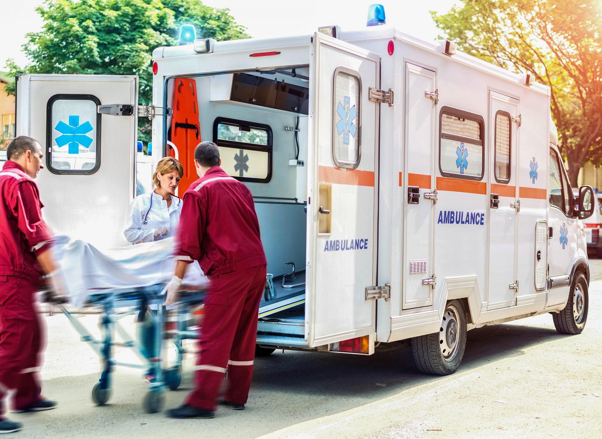 A patient is loaded into an ambulance