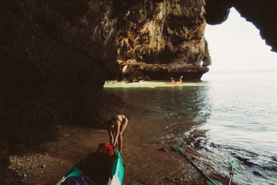 Woman pulling kayak into the water