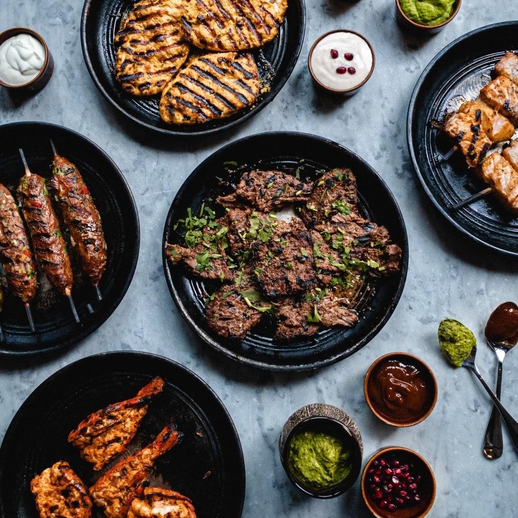 a selection of dishes from Cinnamon Club's father's day meal kit, from kebabs to chutneys and sauces and grilled meats and proteins