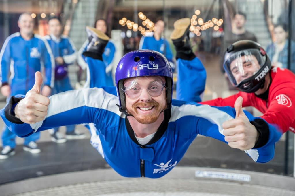 A man flying in a wind tunnel at iFLY in the O2 Arena